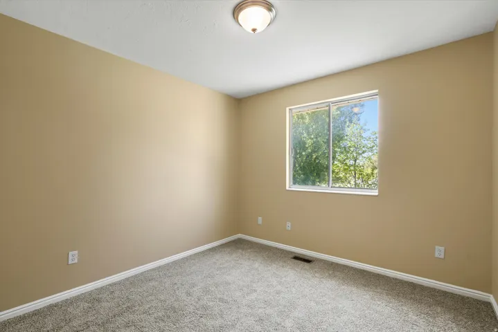 Neutral-toned walls complement plush carpeting