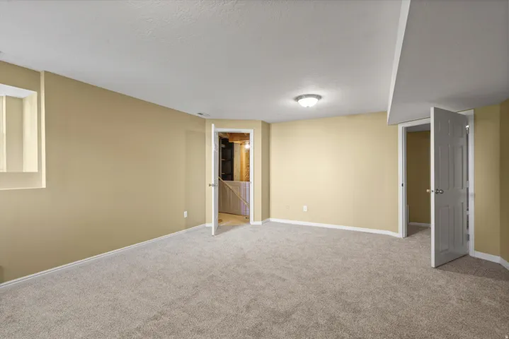 Recessed window, neutral wall paint, carpet flooring, flush mount lighting, white trim