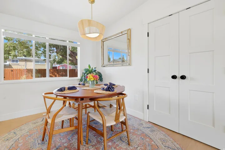Bright interior with wood-finish flooring, a multi-pane window, and a built-in light fixture