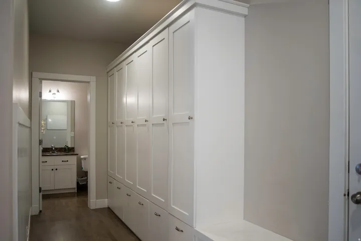 Built-in white shaker cabinetry lockers with ample storage