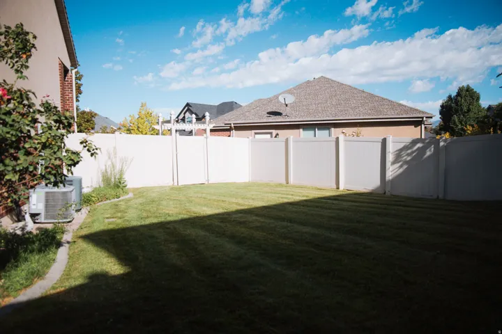 Expansive grassy yard with full perimeter fencing