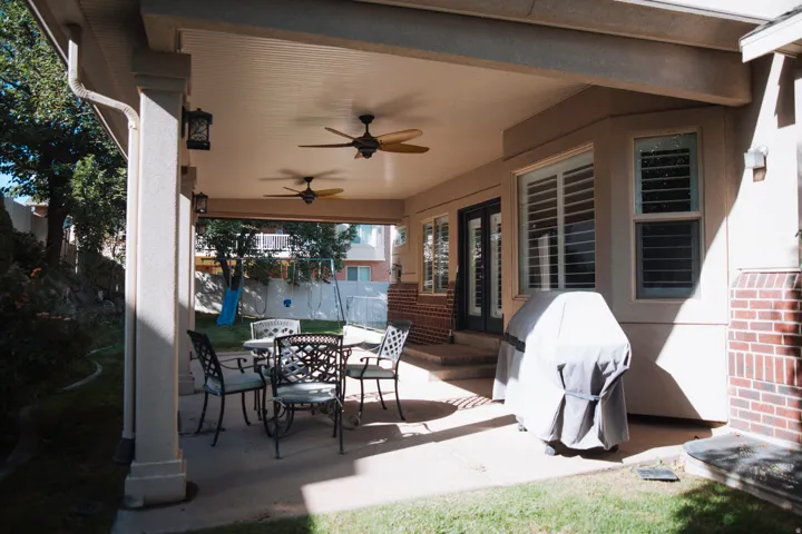Covered patio with dual ceiling fans, recessed lighting, and direct access to the backyard