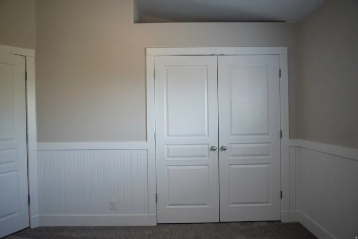 Panel doors, decorative wainscoting, and neutral wall tones