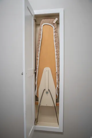 Built-in ironing board with a white cabinet door