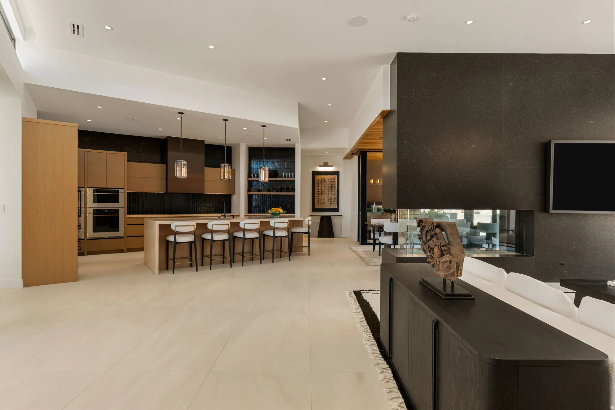 Spacious open-concept interior with light-toned flooring