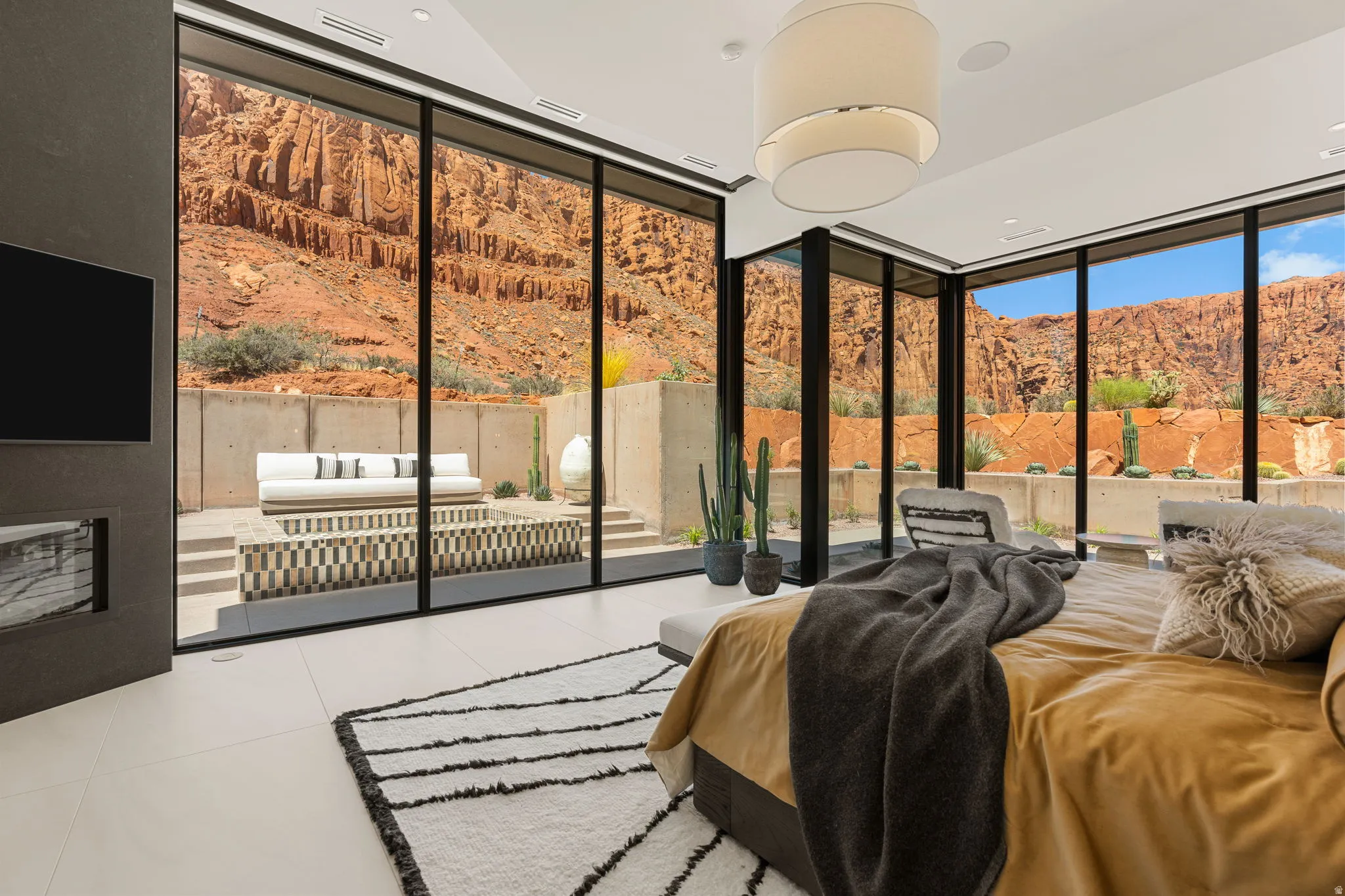 Floor-to-ceiling windows, recessed lighting, and light-toned flooring characterize this space