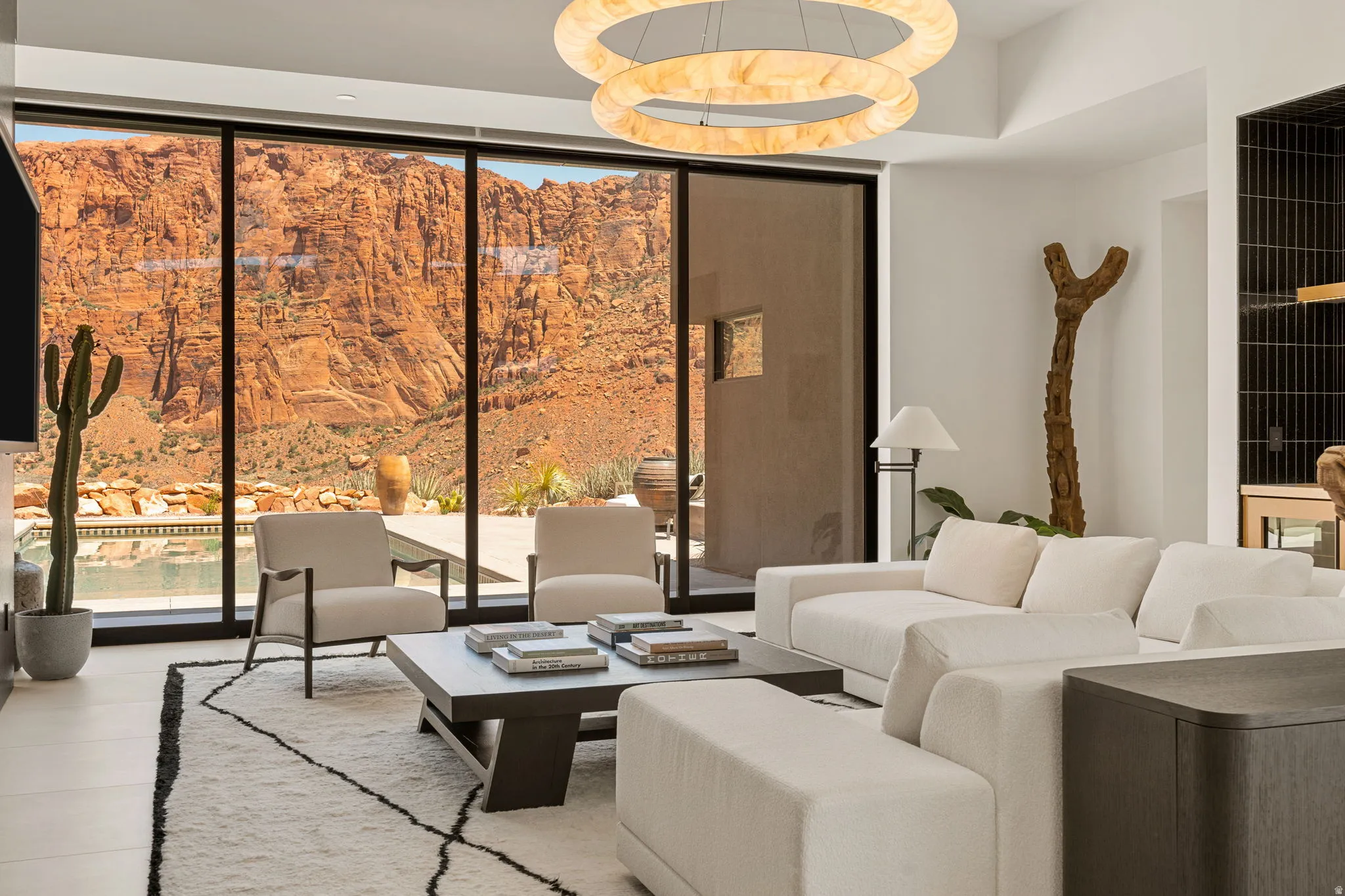 Floor-to-ceiling windows, recessed lighting, modern chandelier, polished concrete flooring, built-in shelving