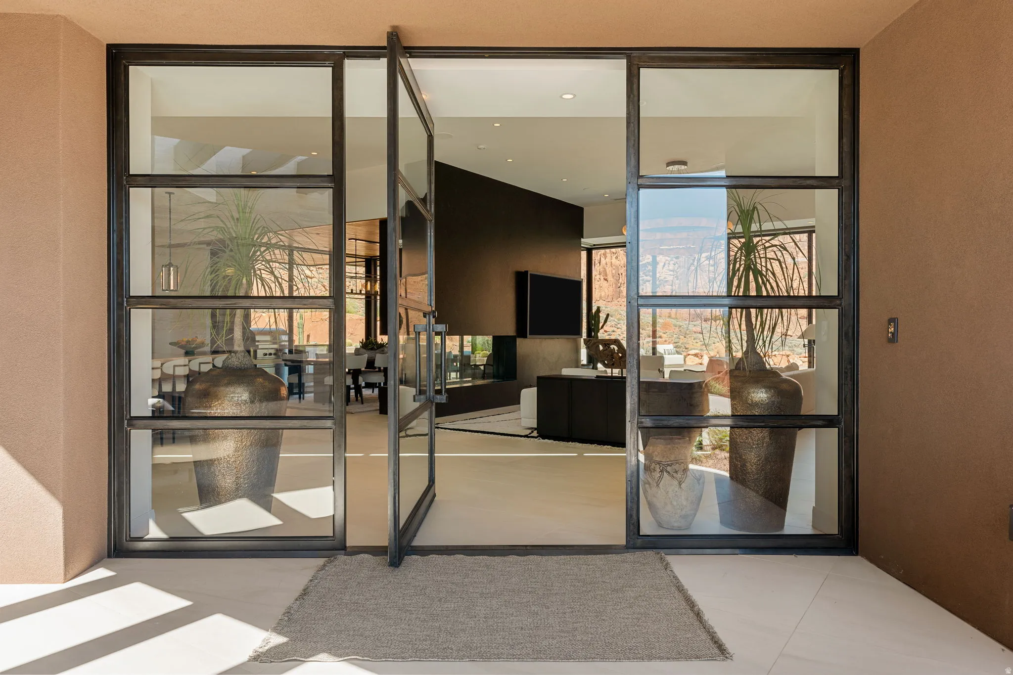 Expansive entry with multi-pane glass and metal-framed double doors