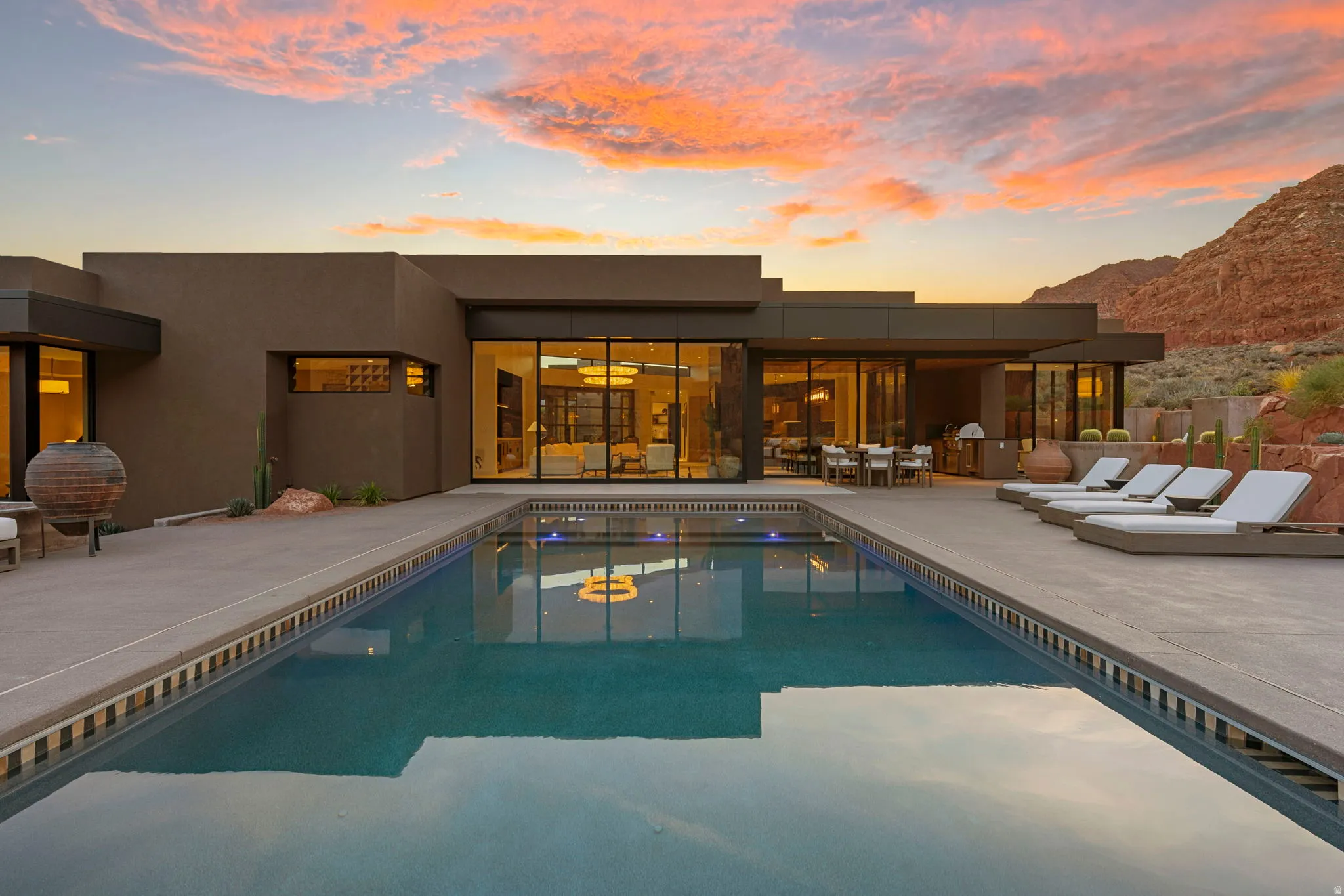 Modern exterior with a rectangular swimming pool, expansive patio, and large sliding glass doors