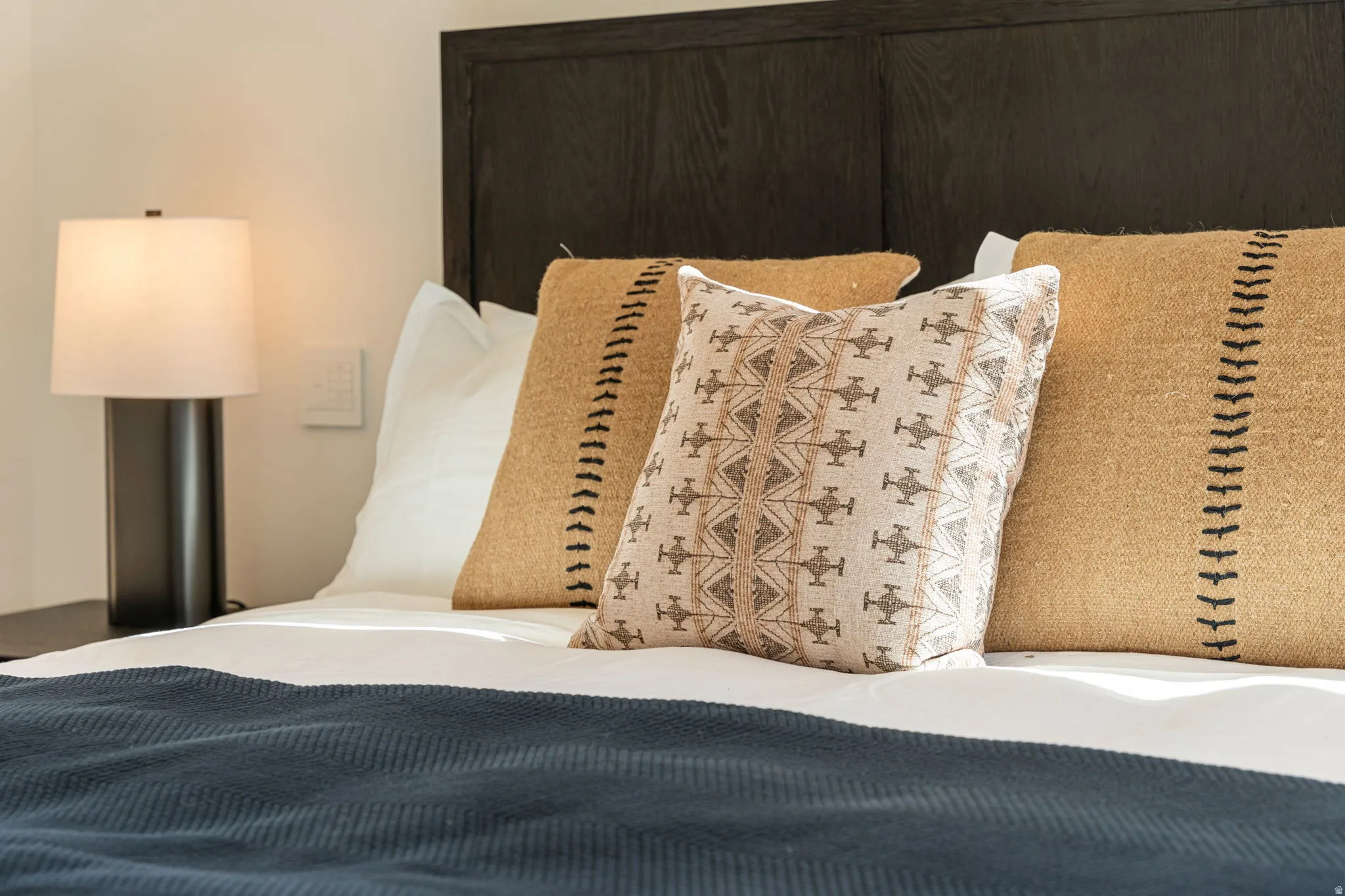 Dark wood headboard with a panel design