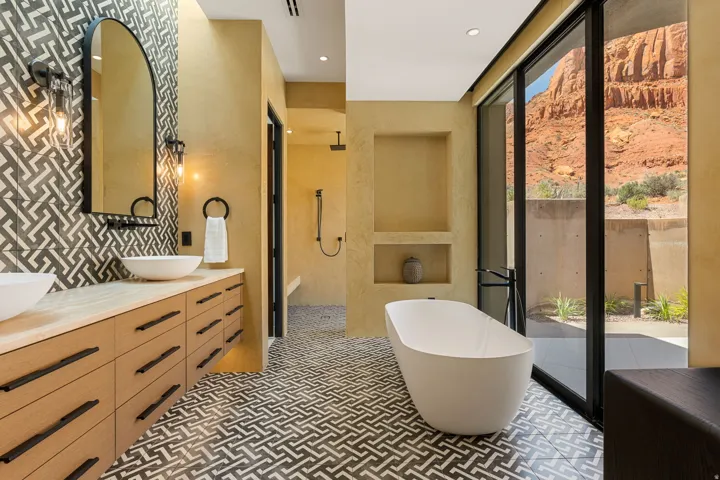 Dual vessel sinks on a wood-finish vanity with black hardware