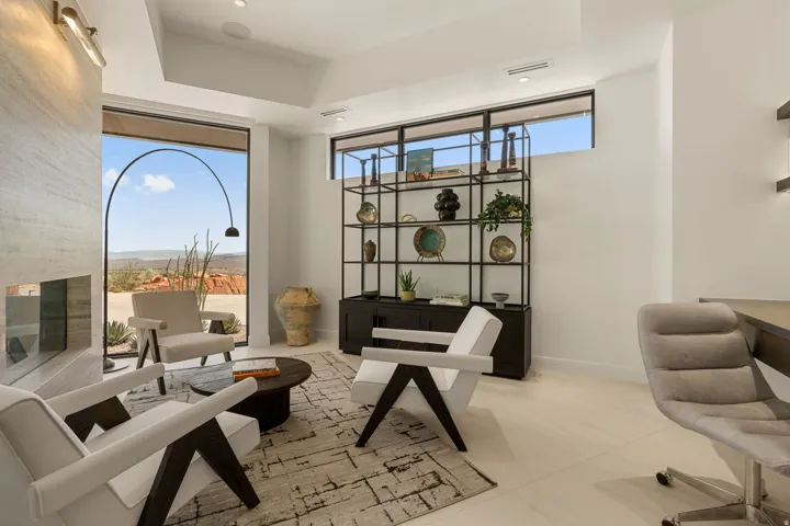 Full-height window, integrated fireplace, recessed lighting, and built-in shelving unit