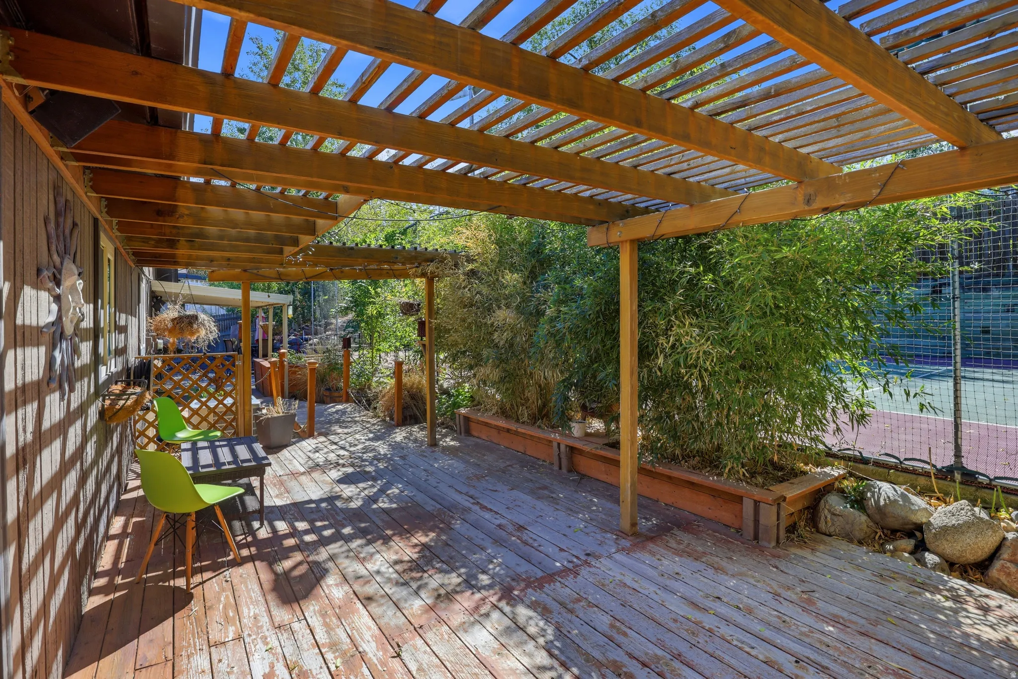 Expansive wood deck with a slatted pergola overhead