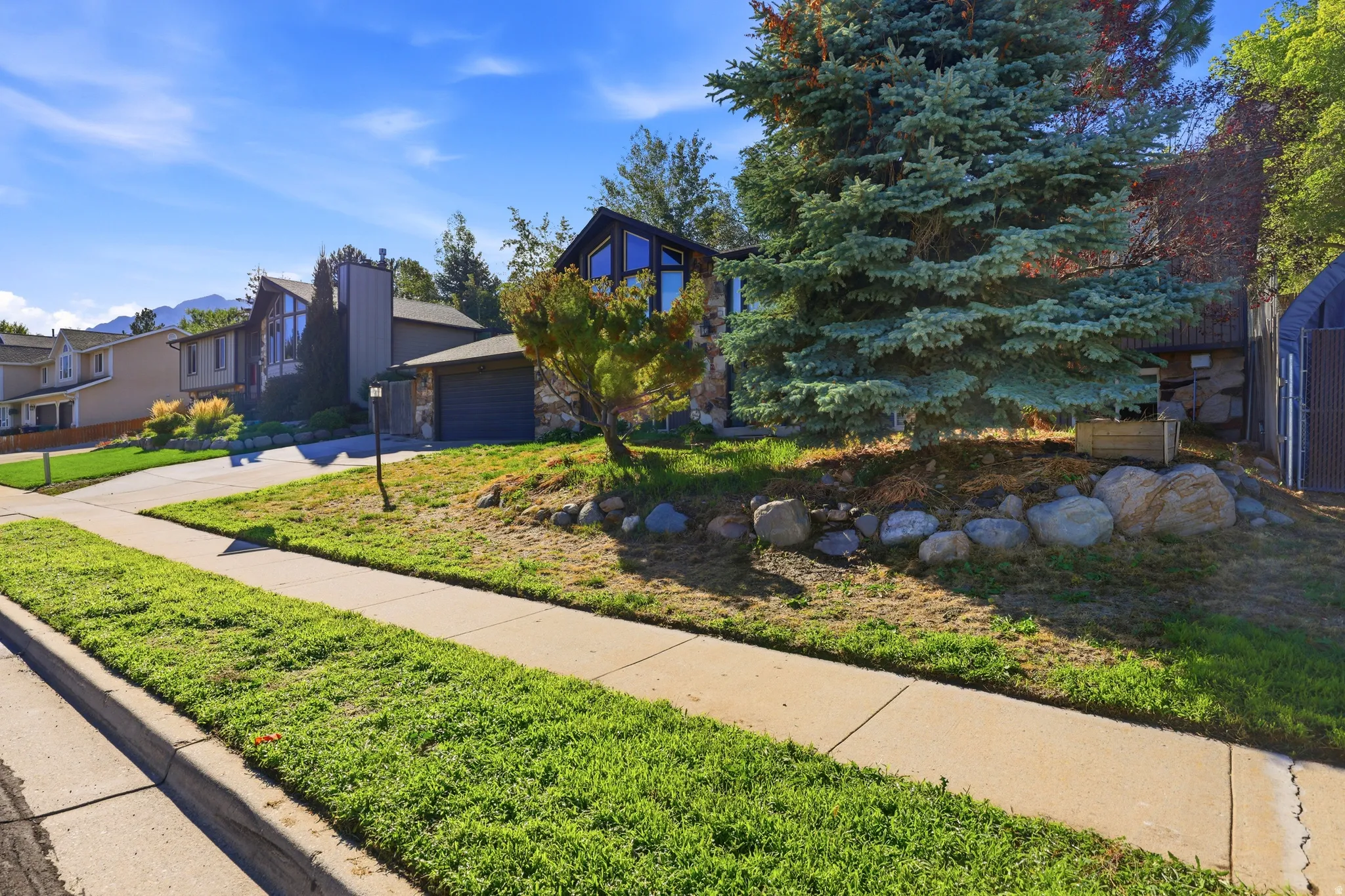 Split-level exterior with stone facade accents and a two-car garage