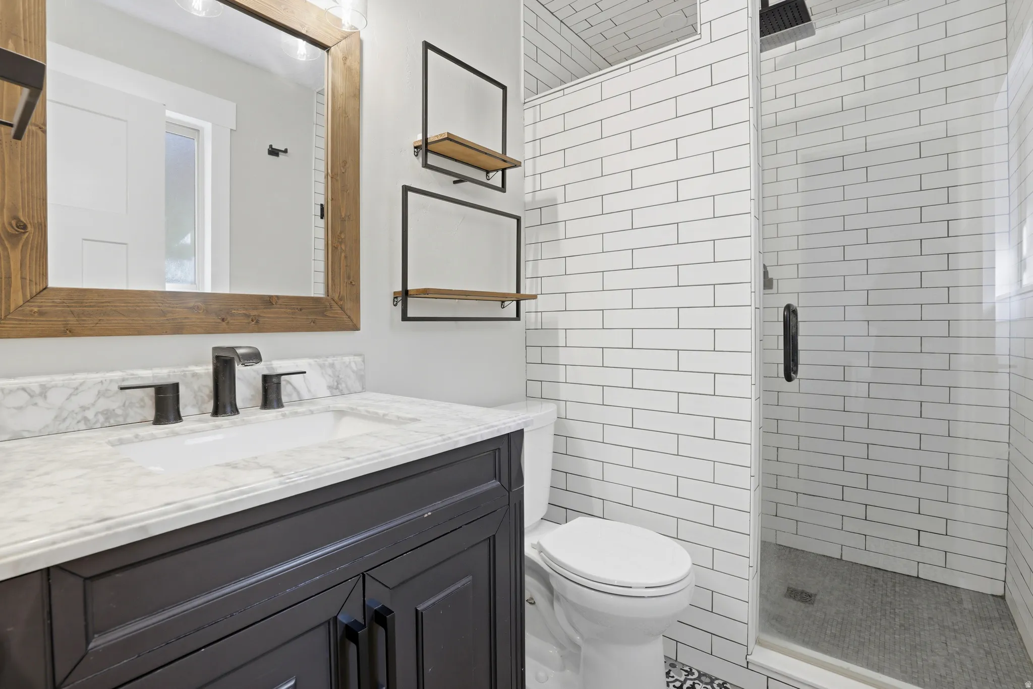 White subway tile shower with a glass enclosure