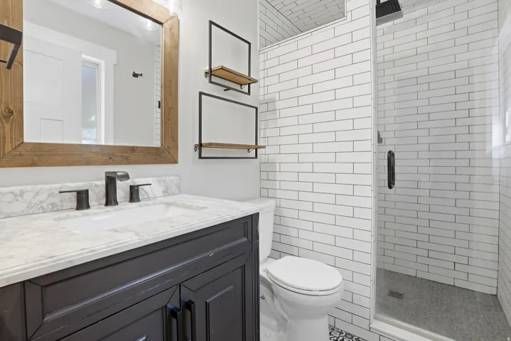 White subway tile shower with a glass enclosure