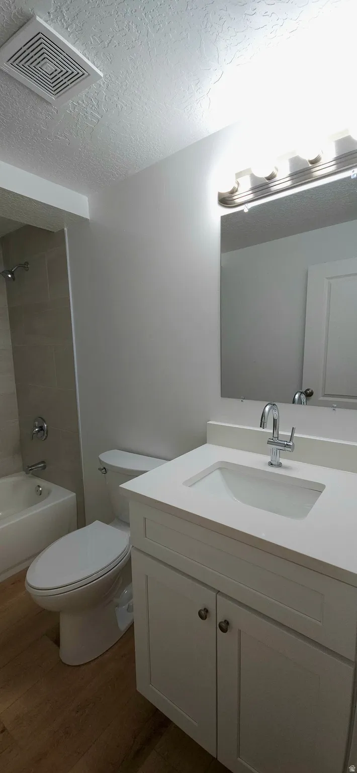 White vanity with cabinet storage, integrated sink, and chrome faucet