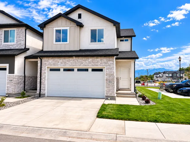 Contemporary exterior with stone veneer accents, an attached two-car garage, and a concrete driveway