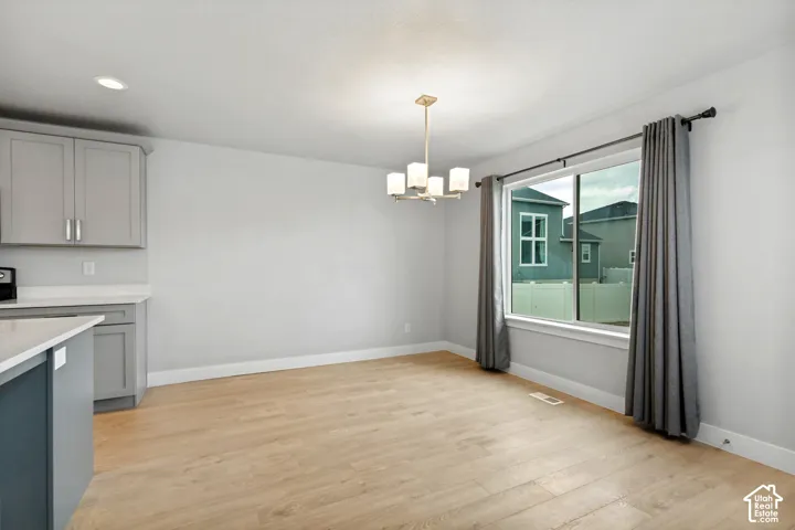 Recessed ceiling lighting, wood-finish flooring, and a large window
