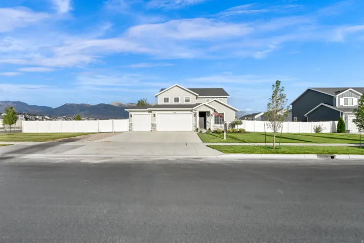 Contemporary two-story residence with a light gray exterior and white trim