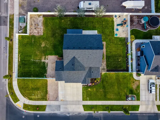 Expansive lot with lush green lawns and a paved driveway
