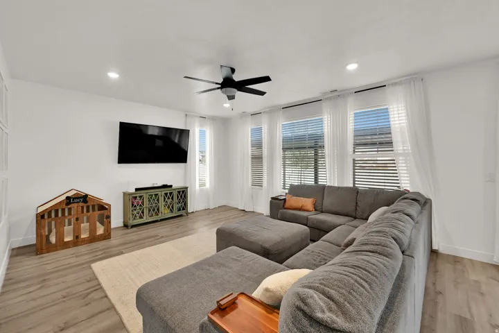 Recessed lighting, ceiling fan, wood-finish flooring, and multiple windows