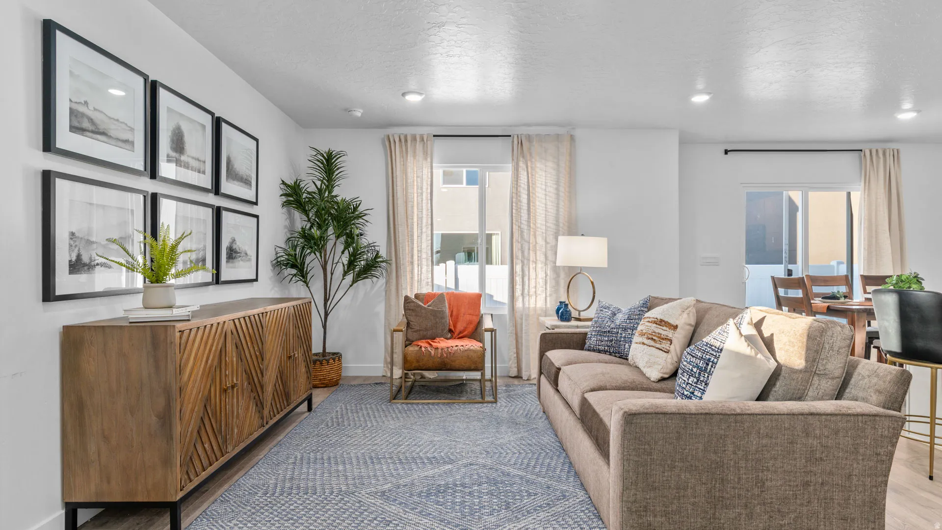 Recessed ceiling lighting, wood-finish flooring, and white walls
