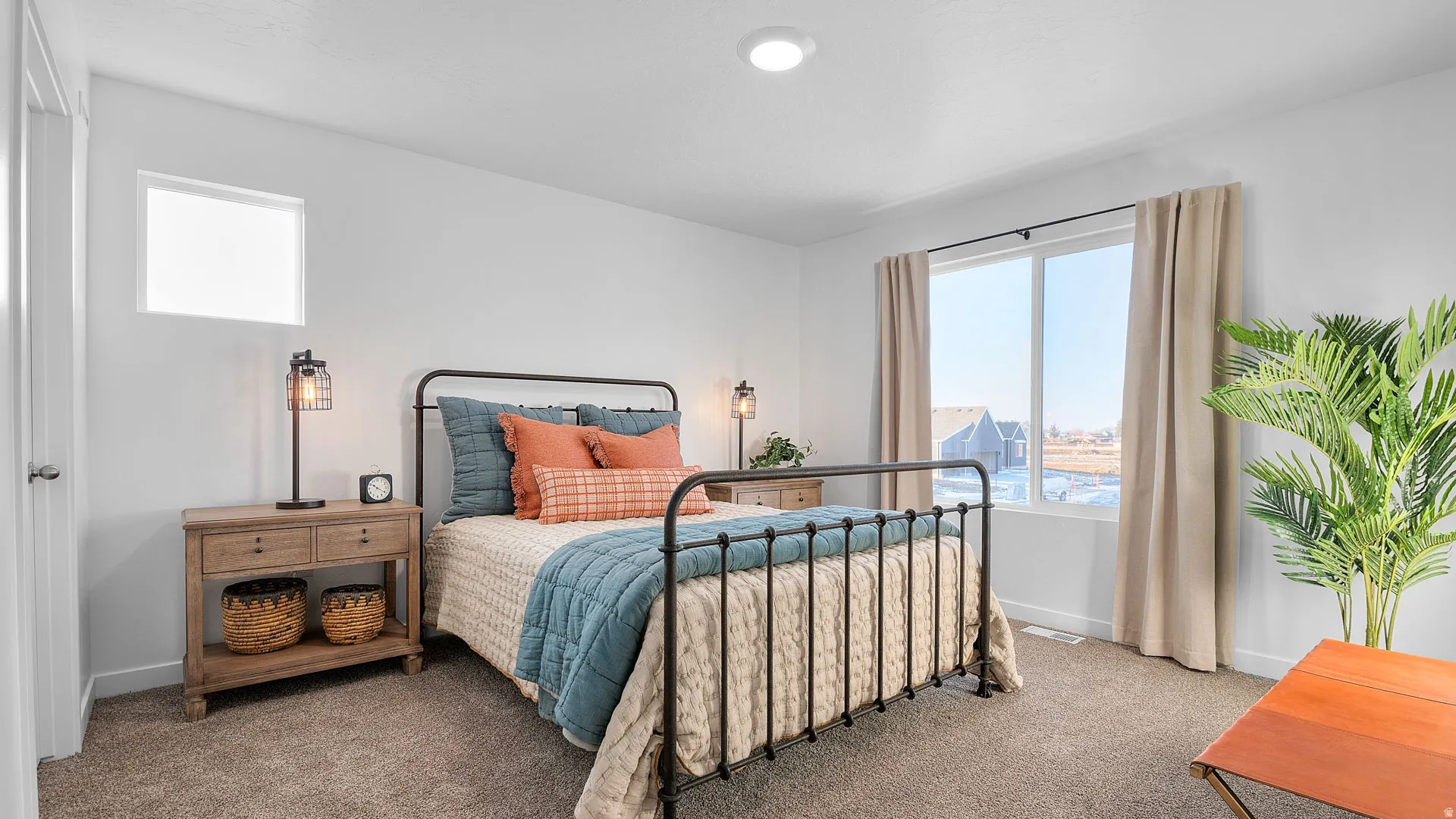 Carpeted flooring, recessed ceiling lighting, and a large window with white trim
