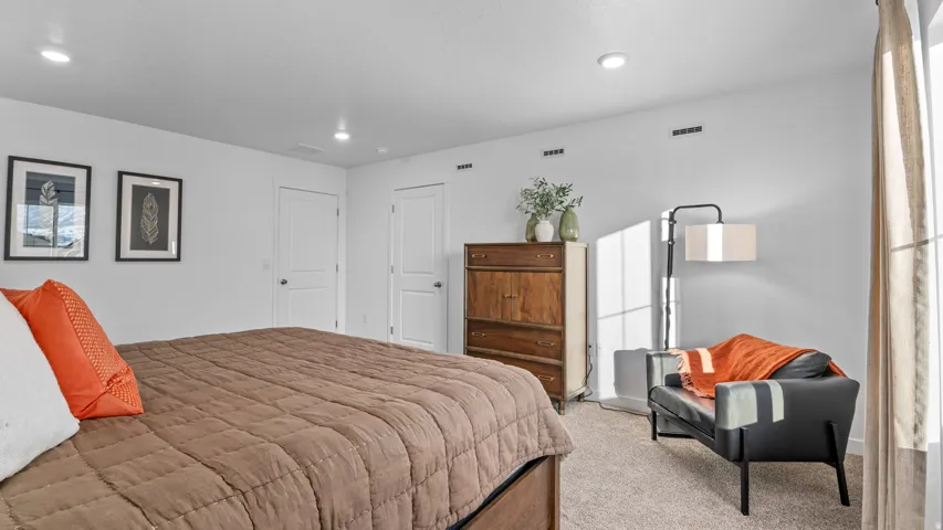 White walls, recessed lighting, two panel doors, and neutral carpeting