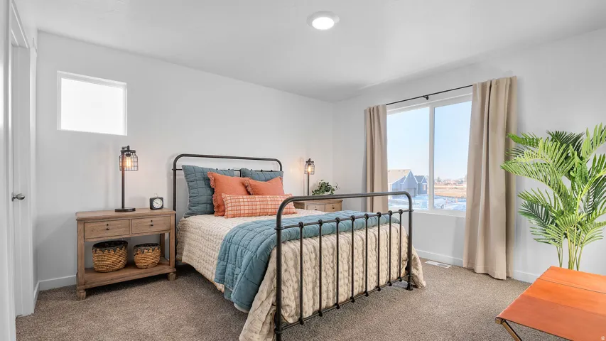 Carpeted flooring, recessed ceiling lighting, and a large window with white trim