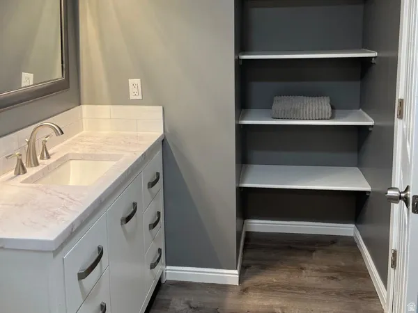 Bathroom in Master Suite  Vanity with white cabinetry, undermount sink, and stone-finish countertop