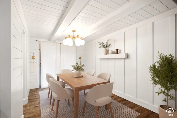 THIS ROOM HAS BEEN VIRTUALLY STAGED Board-and-batten wall detailing, horizontal shiplap wall finishes, exposed structural ceiling beams, wood-finish flooring, and a multi-globe brushed-gold chandelier