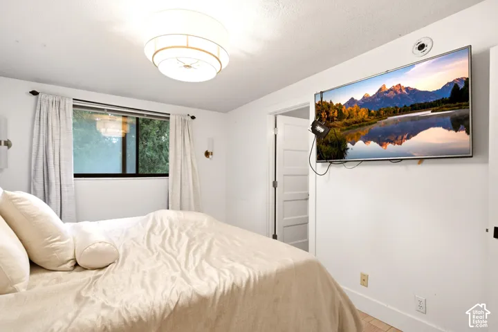 Multi-tiered drum light fixture, wall-mounted metallic sconces, and interior door with horizontal panel detailing