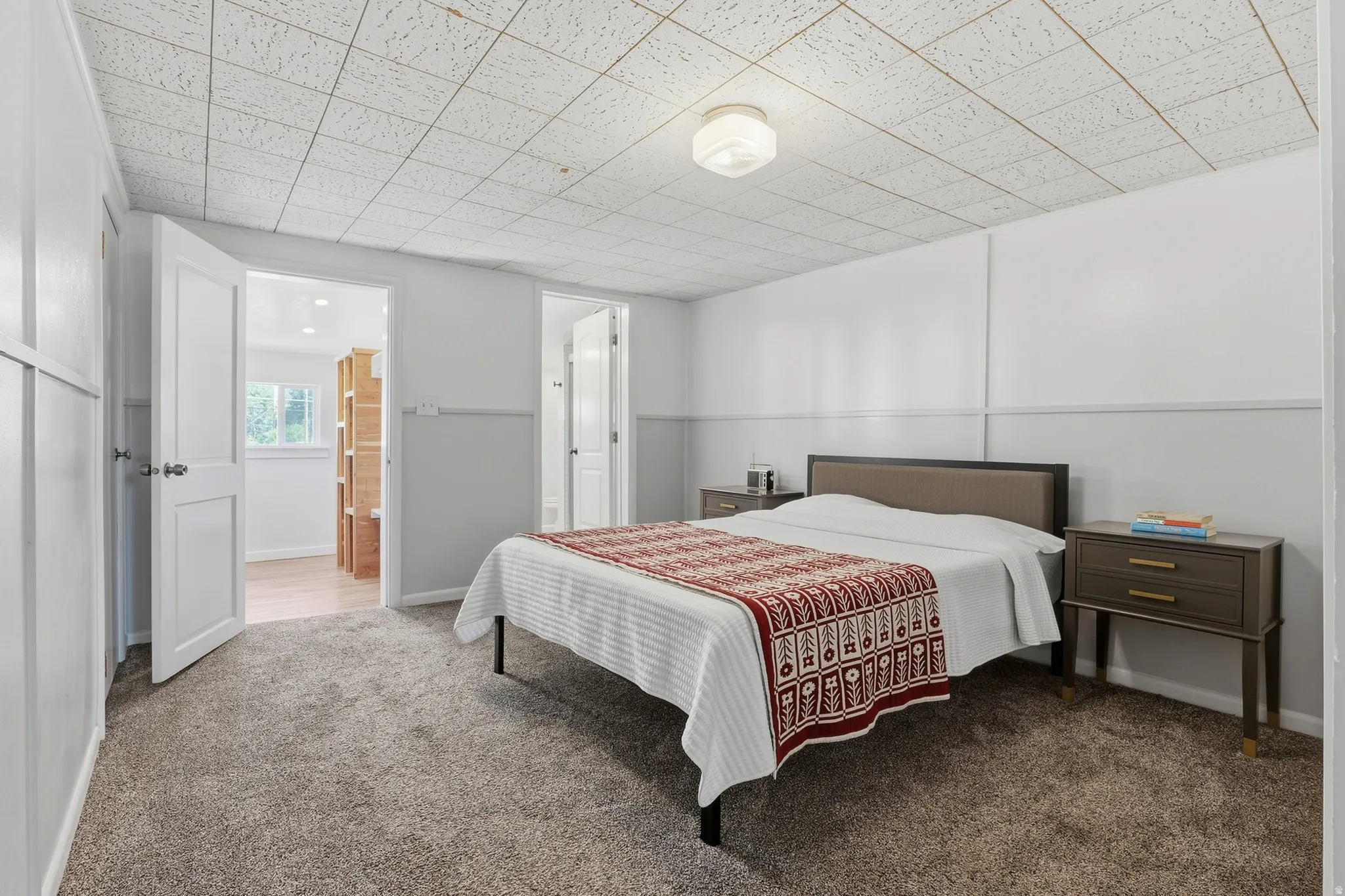 Carpeted flooring with light-toned walls and paneled doors