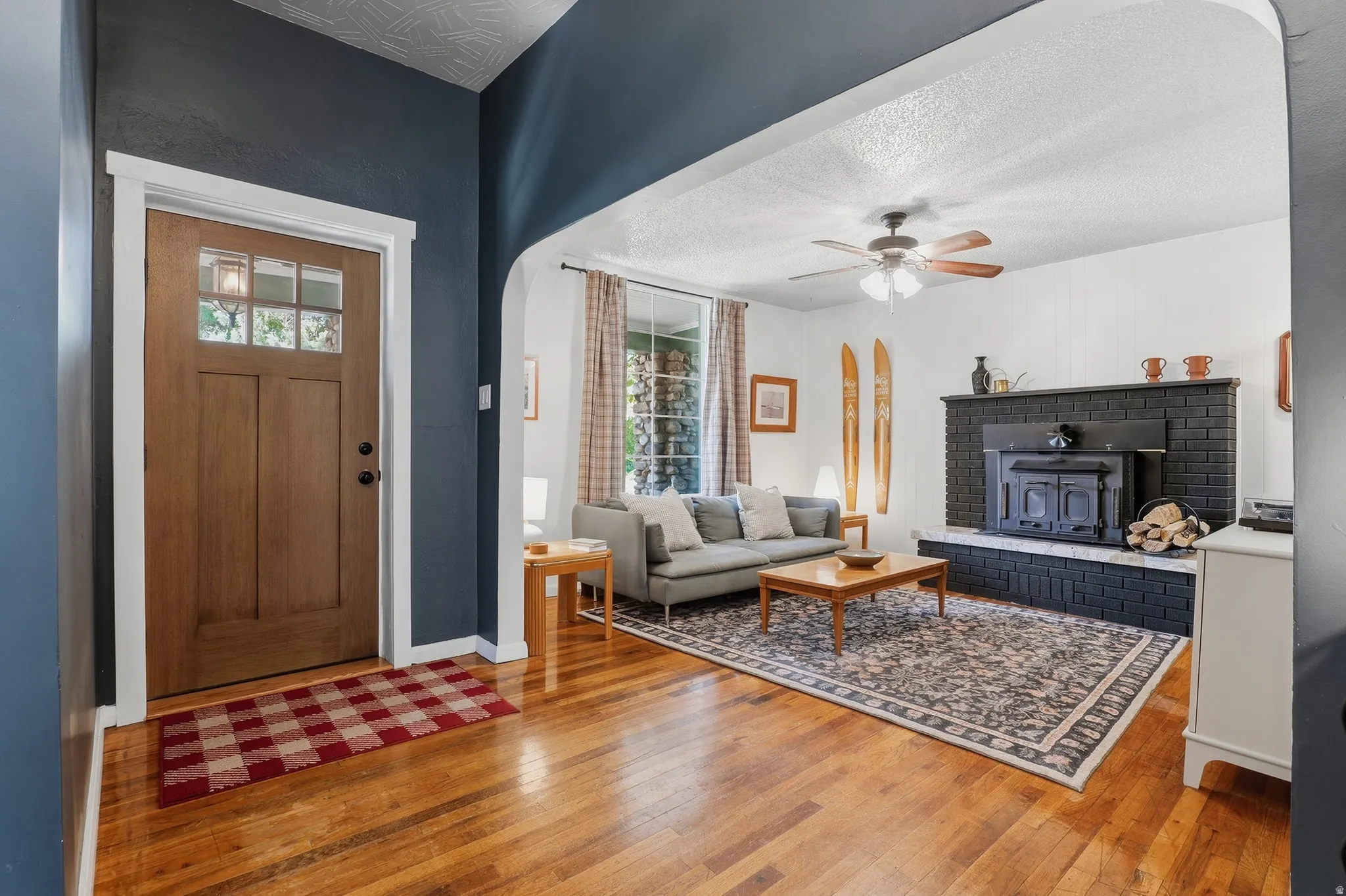 Wood-finish flooring throughout, with a wood-paneled entry door featuring divided lites
