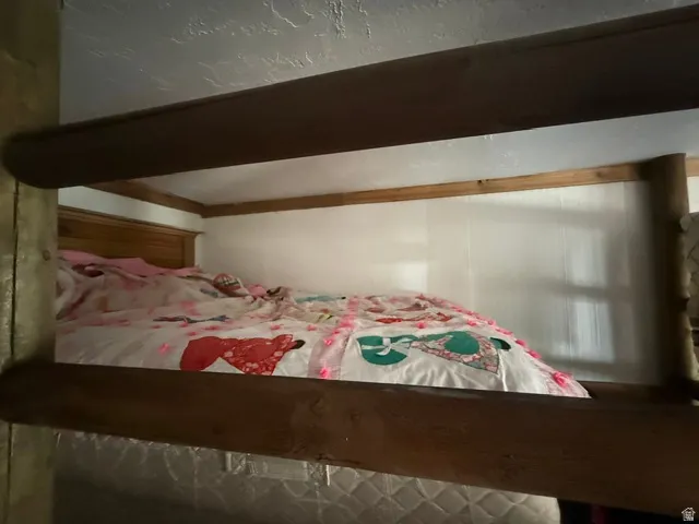 Wood-paneled headboard with a white wall and wood trim