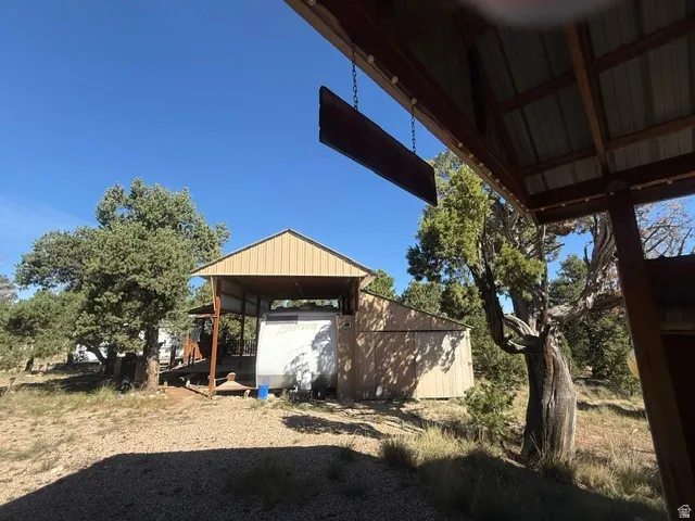 Covered shelter structure with wood-finish siding and a gabled roof
