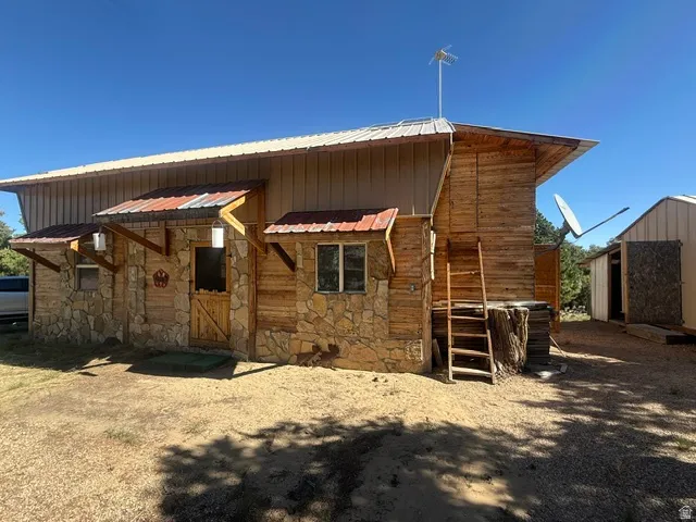 Stone and wood-finish exterior with a metal roof