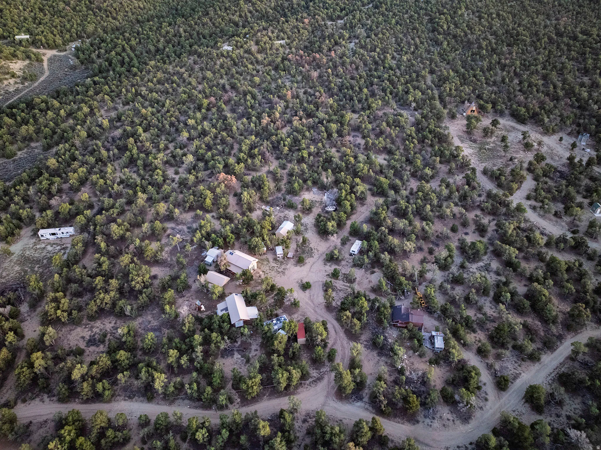 Expansive, wooded terrain with multiple structures