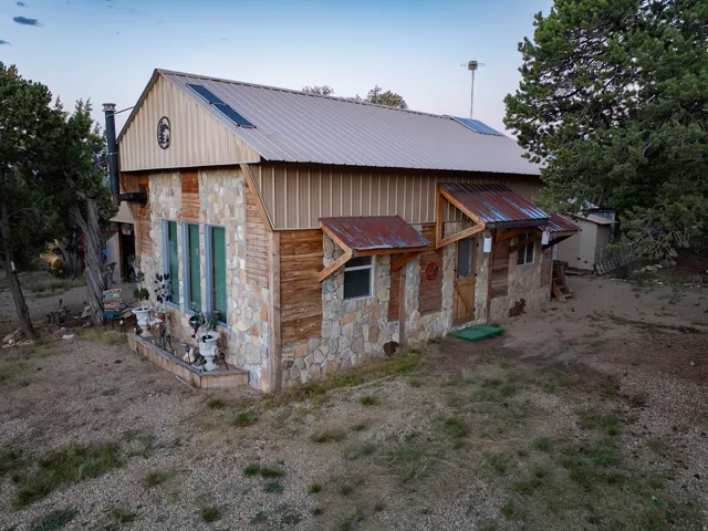Stone and wood-sided exterior with a metal roof