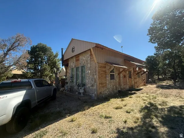 Stone and wood-sided exterior with a metal roof