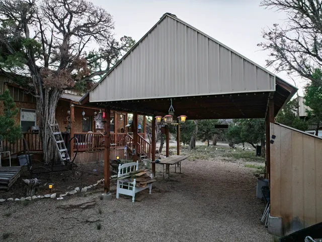 Wood-sided exterior with a covered porch and railing