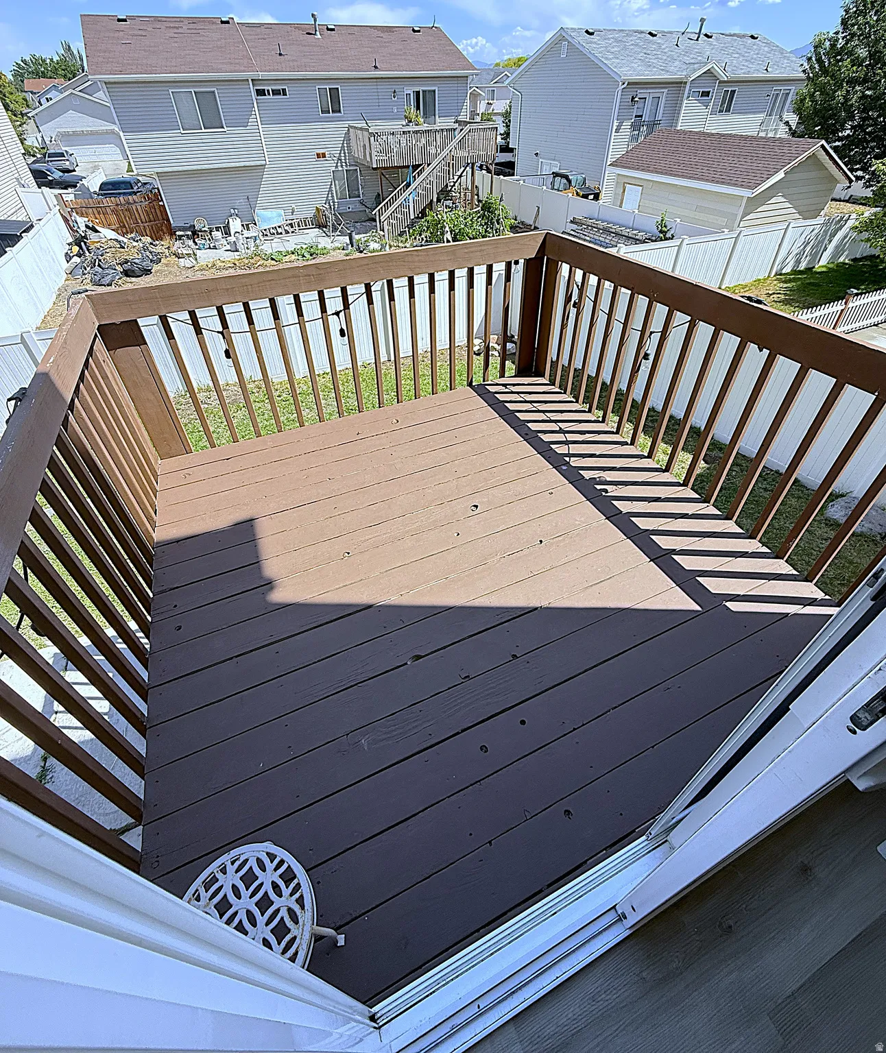 Wooden deck with brown finish and matching railing