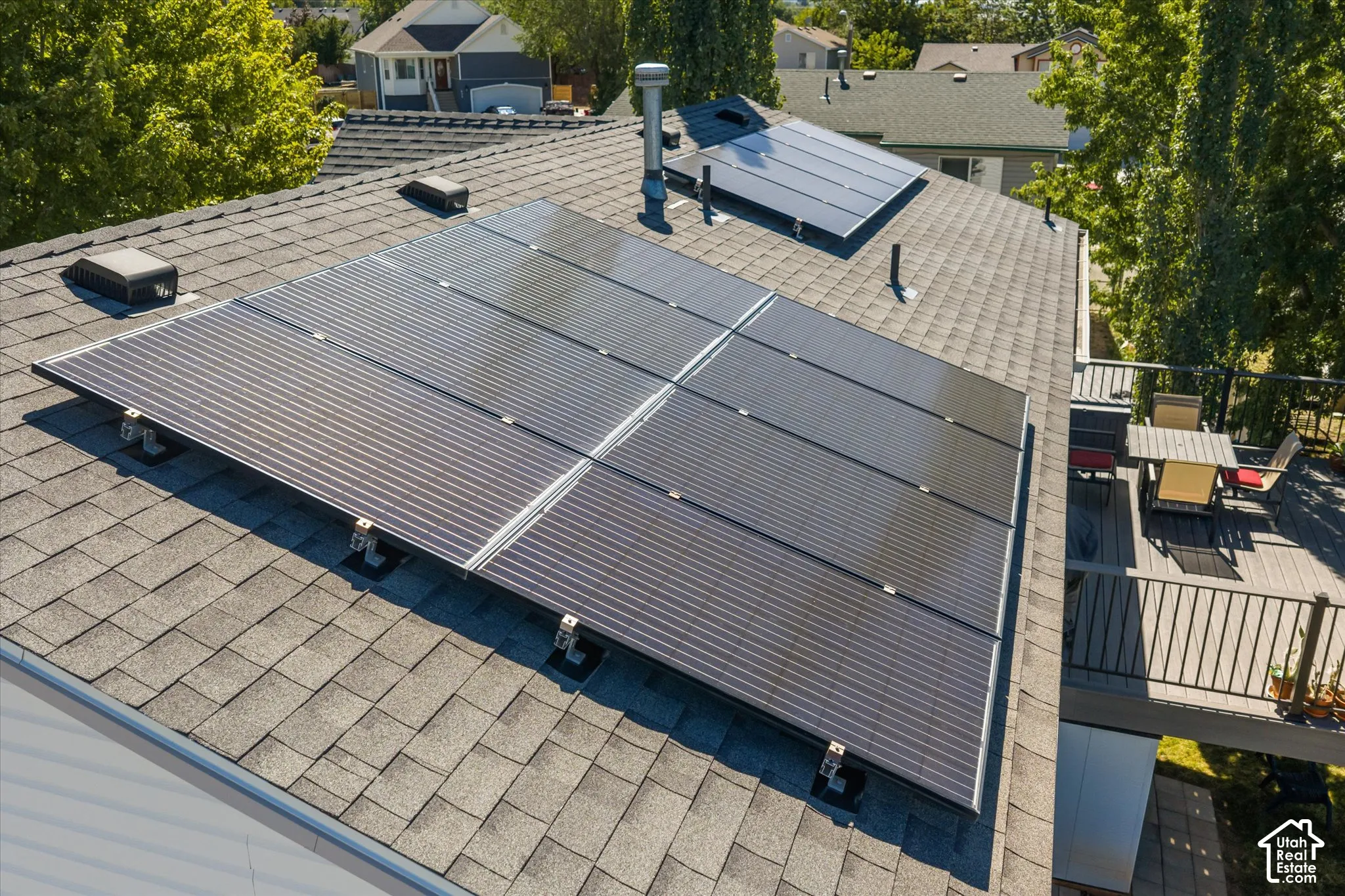 Asphalt shingle roofing with multiple solar panel arrays