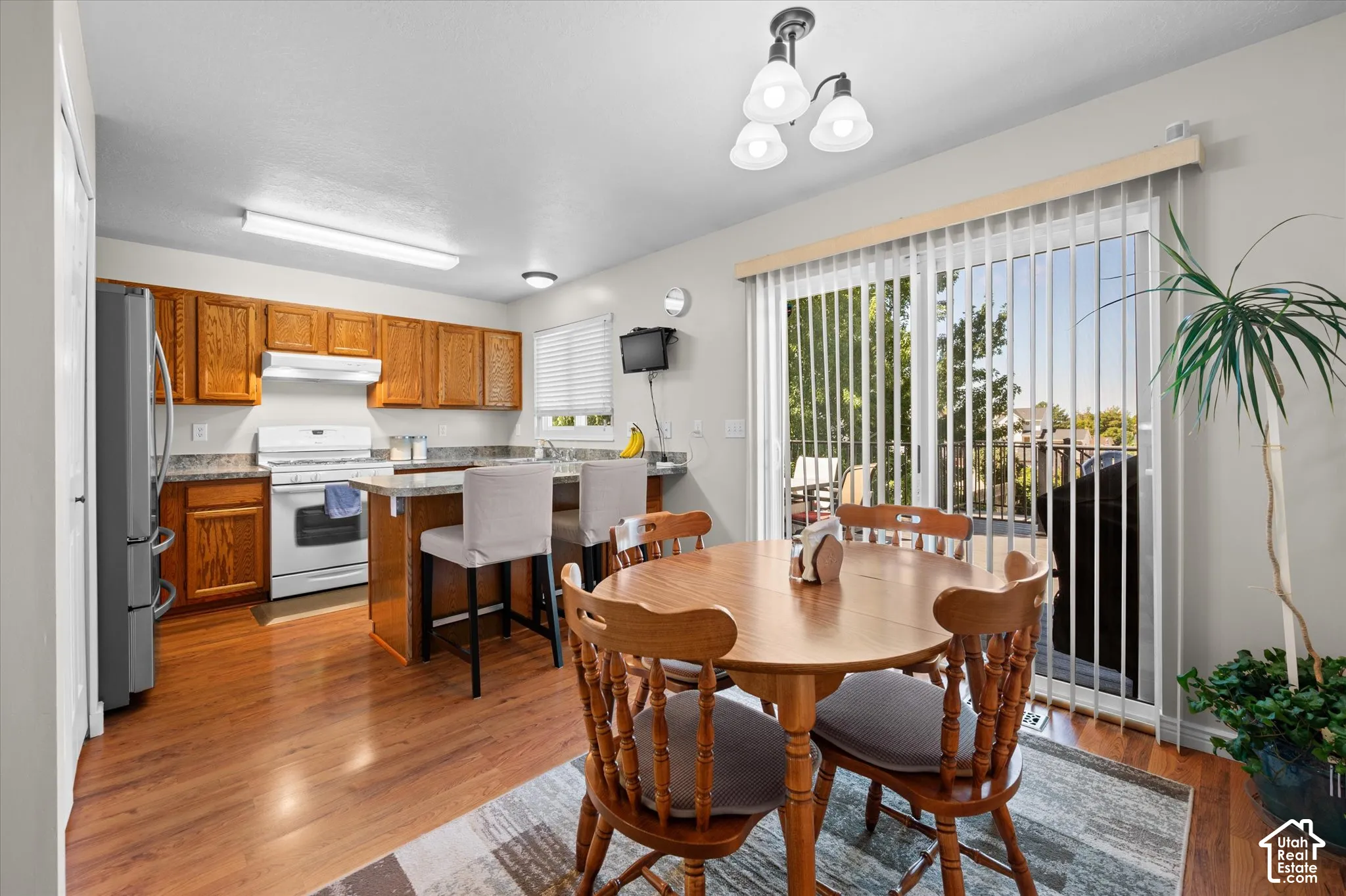 Wood-finish laminate flooring throughout the kitchen and dining area