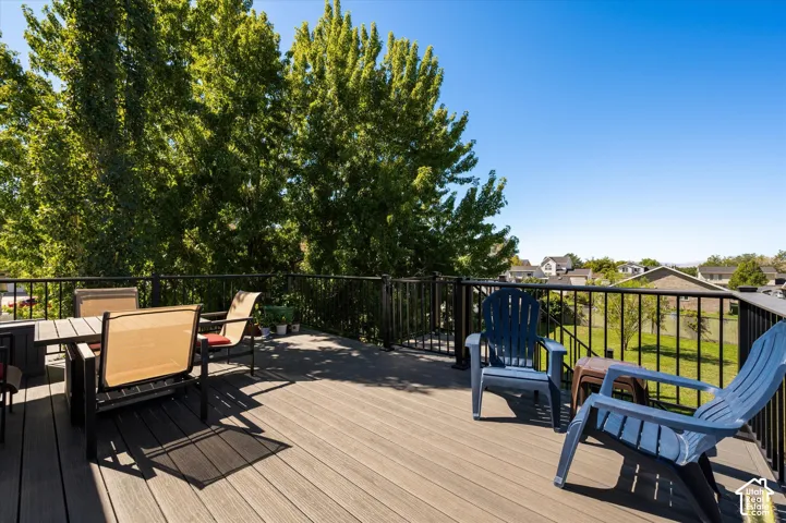 Expansive outdoor deck with composite decking and black metal railing