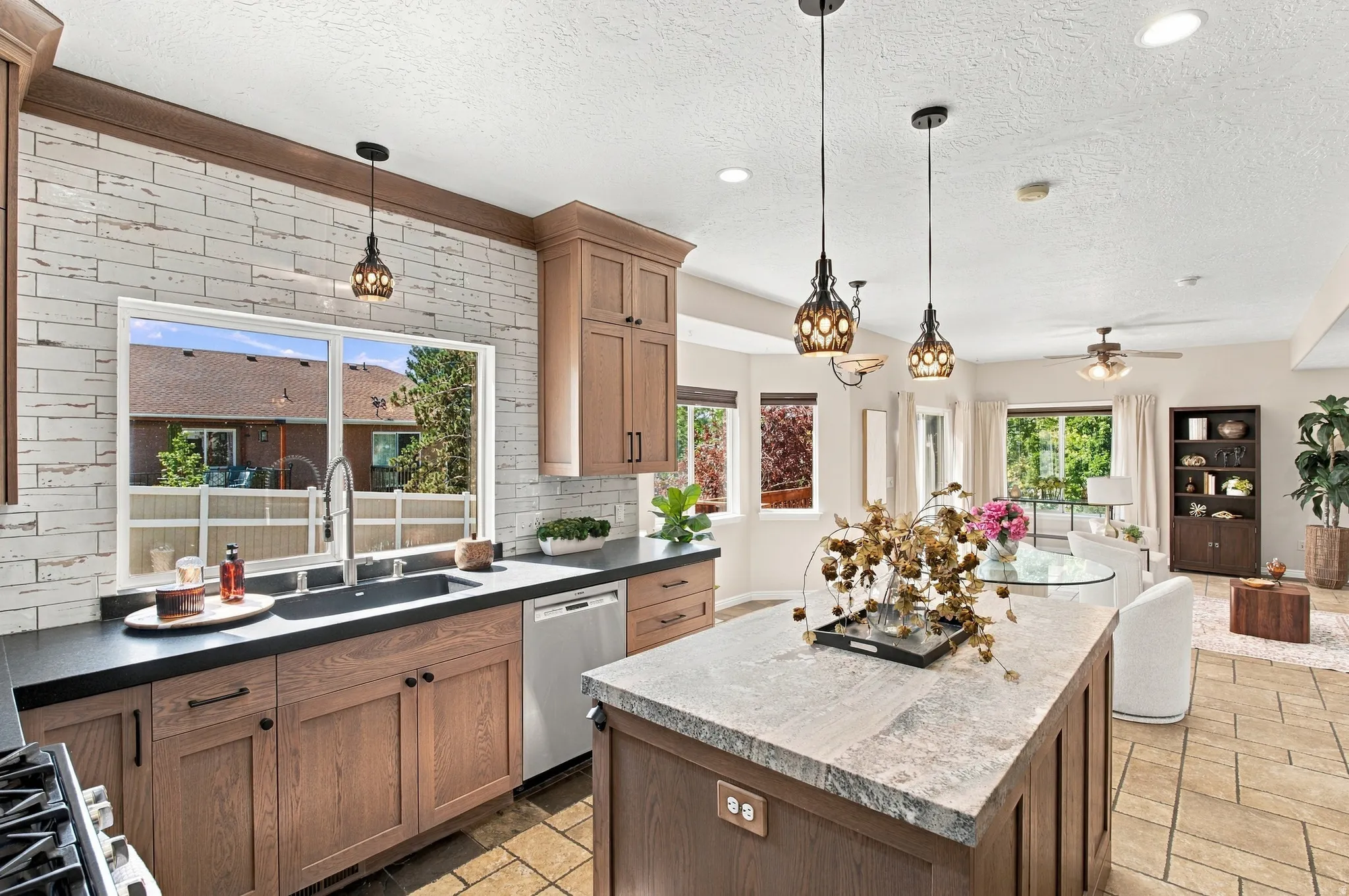 Premium handmade-look ceramic subway tile.  Rustic yet refined with an artisan, old world look.  Blanco farmhouse, matte black sink recessed into granite countertop.