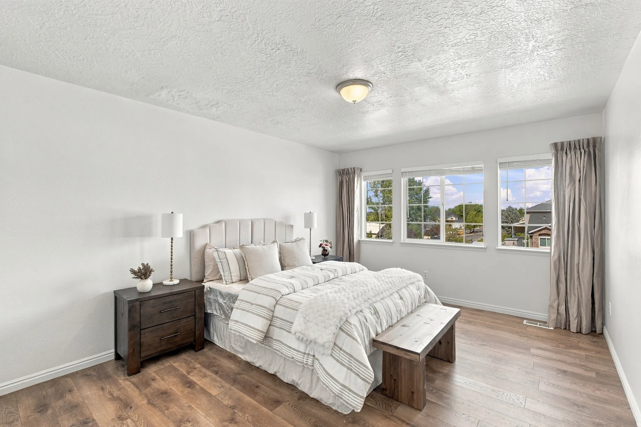 Very spacious fourth bedroom with three windows and beautiful, brand new, high end laminate flooring.