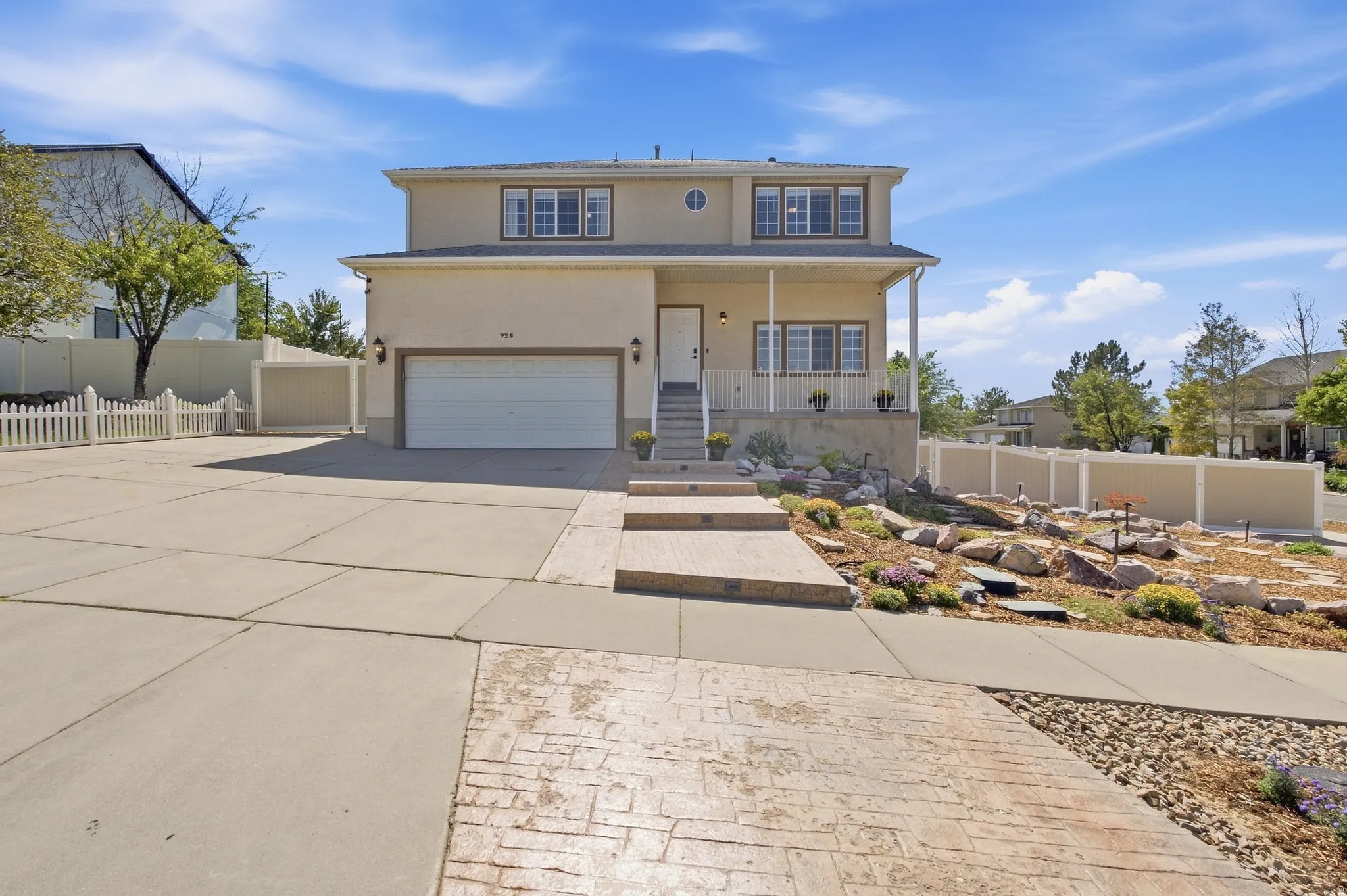 Stucco exterior with covered front porch and custom stamped concrete and plenty of parking.