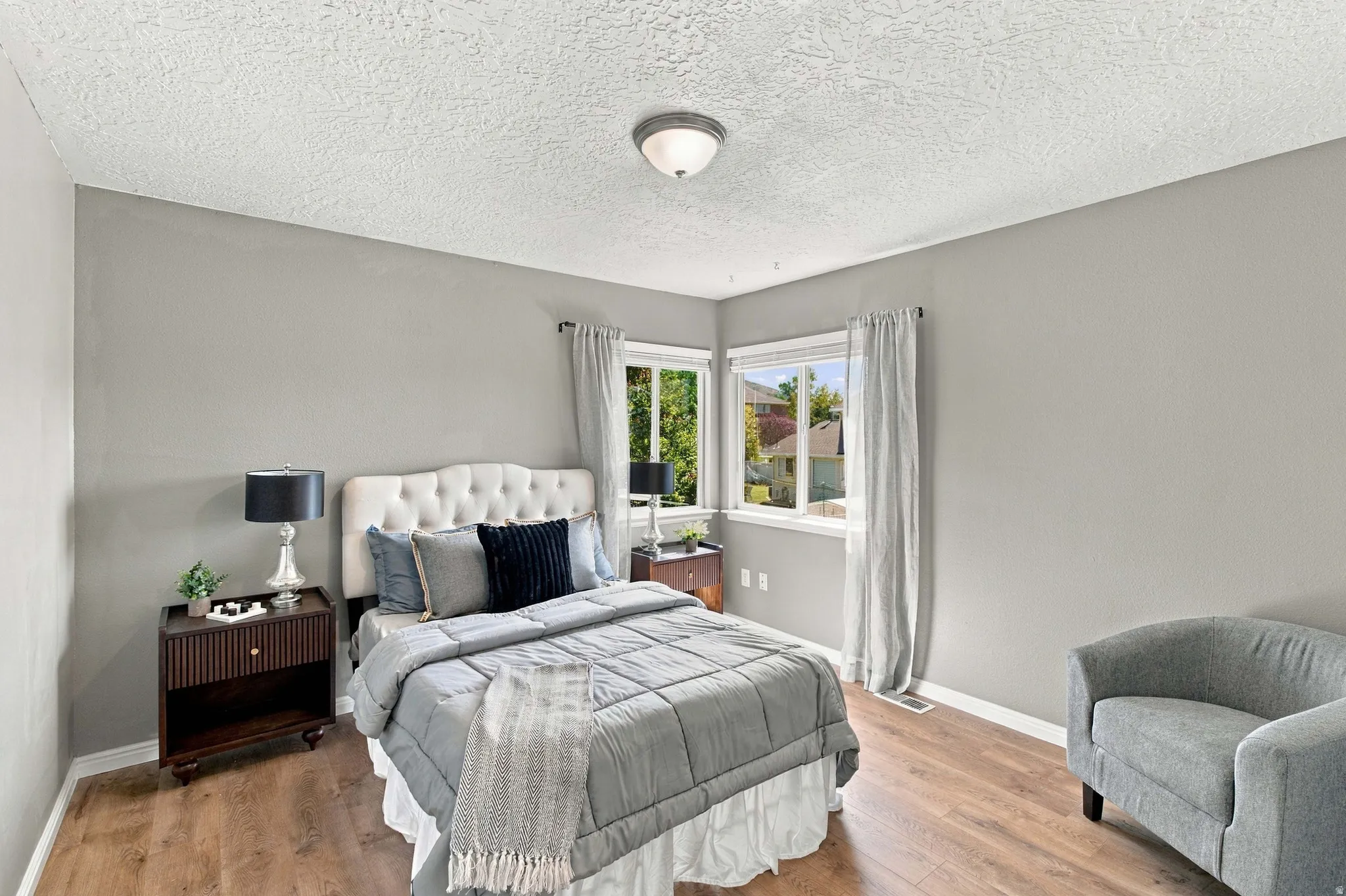 Second bedroom with corner windows overlooking the backyard with big walk in closet.